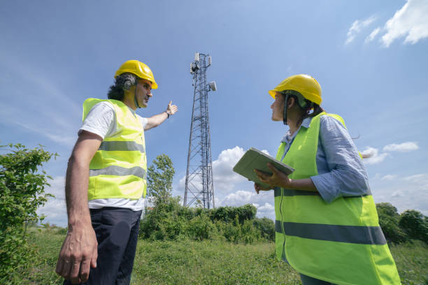 istock Engineers working on the field near a Telecommunications tower. Teamwork. 1304876057