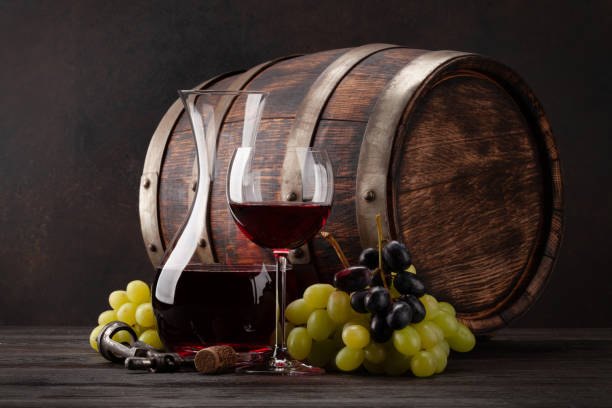 istock Wine decanter, glass and old wooden barrel 1304876268