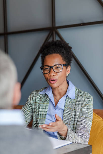 istock African American entrepreneur having a conversation with her colleague. 1304876659