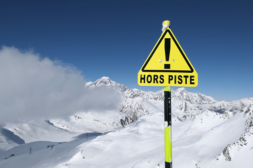 Warning sign 'Hors piste' means Off piste in La Rosiere ski resort. Mount Blanc winter scenic view.