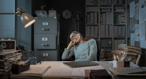 istock Sleepy businesswoman working overtime 1304877732