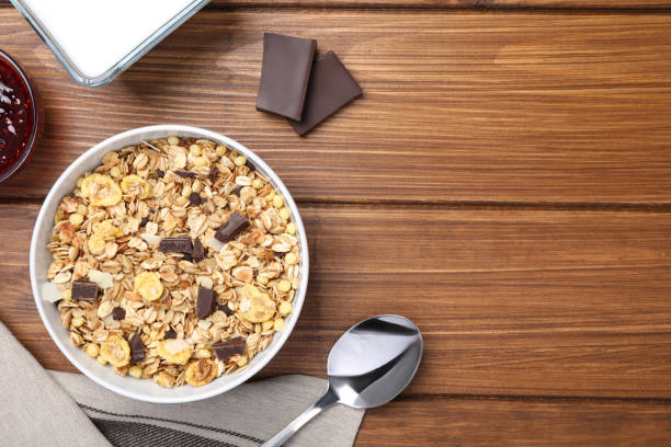 istock Tasty muesli served on wooden table, flat lay. Space for text 1304878681