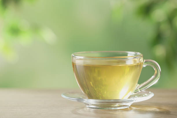 istock Glass cup of fresh herbal tea on table. Space for text 1304878716