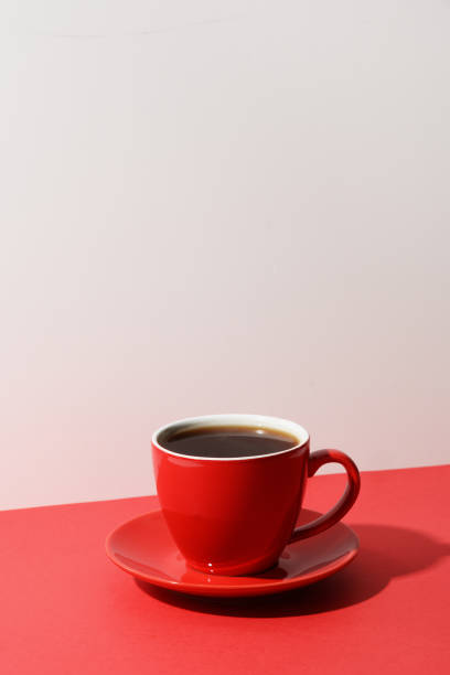 istock Red cup of coffee and beans on red. 1304879769