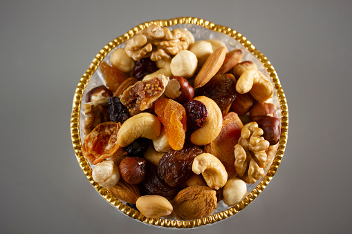 Mixed nuts in a glass plate. Healthy and natural nutrition .Cashew, Almond, Hazelnut, Fig, Walnut, Apricot, Raisin, Blueberry.