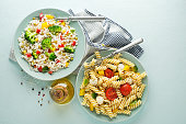 Fresh pasta salad and rice salad with mixed vegetables