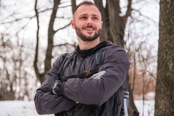 istock Joyful young hiker standing in the forest and smiling 1304880543