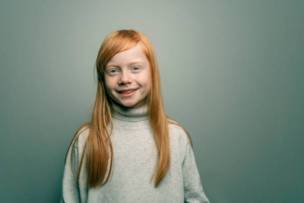 istock Young girl witwith red hair smiling at camera 1304881903