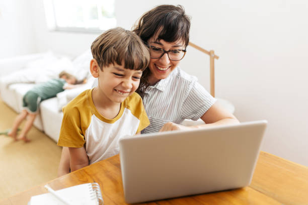 istock Happy young family using laptop at home 1304881961