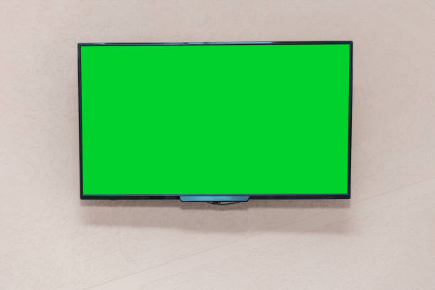 istock Large modern TV set with wide screen with green empty chromakey space 1304883446