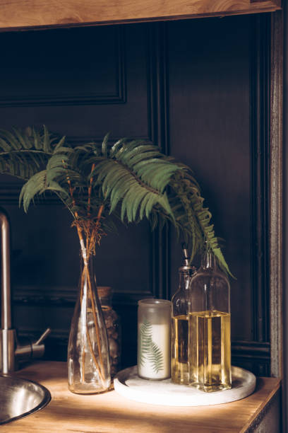 istock Glass bottles and decorative candle on a black background. Home kitchen decor. Home interior decor. 1304888556