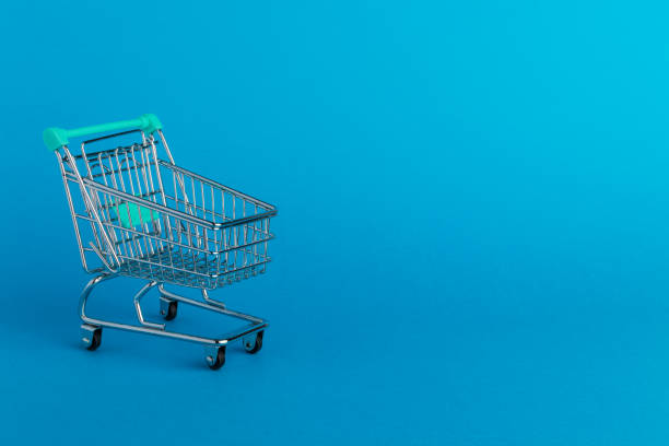 istock Shopping cart trolley on blue background. 1304889000