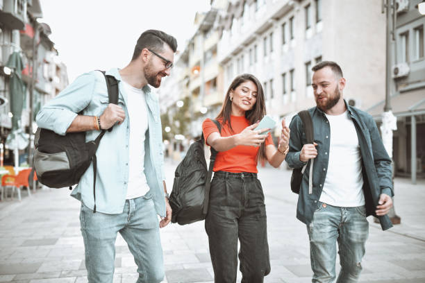istock Smiling Friends Taking Selfie While Sightseeing New City 1304889387