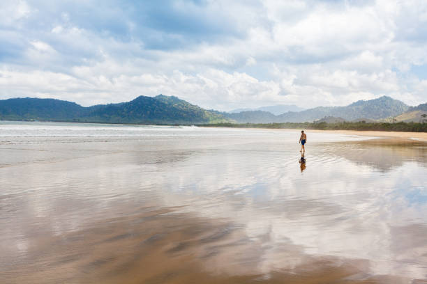 istock Retired man walk by tropical sea beach 1304890224