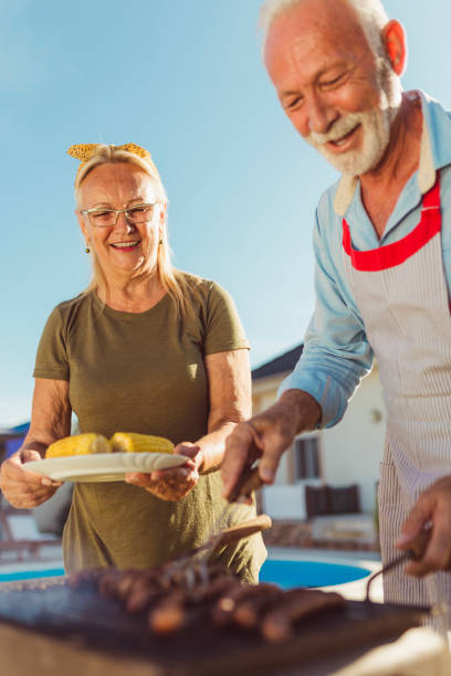 istock Senior couple making barbecue in their backyard 1304896318