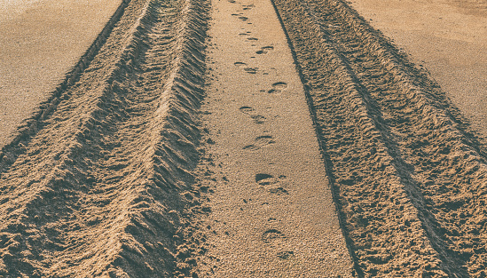 Tire tread marks on sand