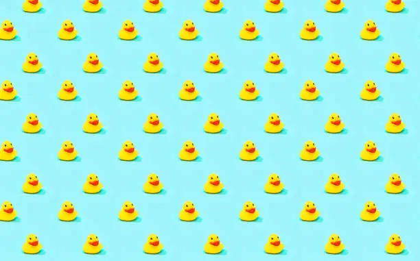 Seamless pattern rubber ducks on a blue background
