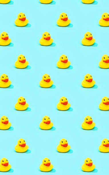 istock Trendy summer pattern with yellow rubber duck on bright blue background. Minimal summer concept. 1304897748