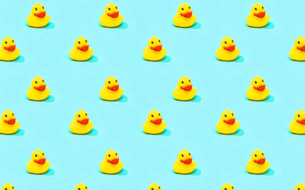 istock Trendy summer pattern with yellow rubber duck on bright blue background. Minimal summer concept. 1304897770