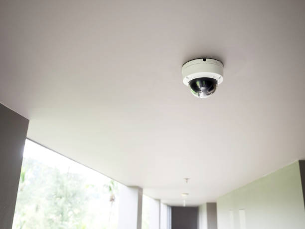 istock CCTV camera on white ceiling at walkway on ground floors. 1304899733