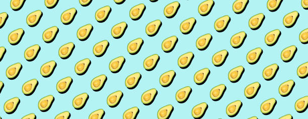 Avocado pattern background. Avocado minimal on a colored background for patterns. Food vegetables backagrund