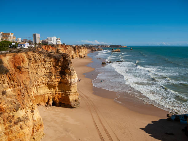 Portimao coast. Cliffs and beaches on a sunny day. Sea and waves