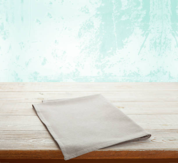 istock Empty white table cloth on wooden desk. Kitchen background. 1304900700