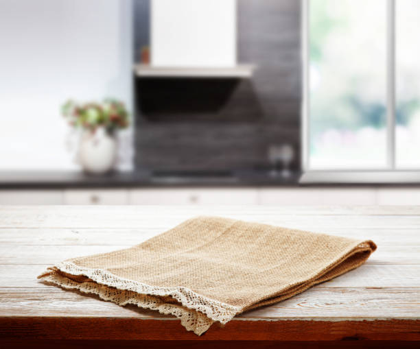istock Napkin on wooden desk perspective. Kitchen background. 1304900740