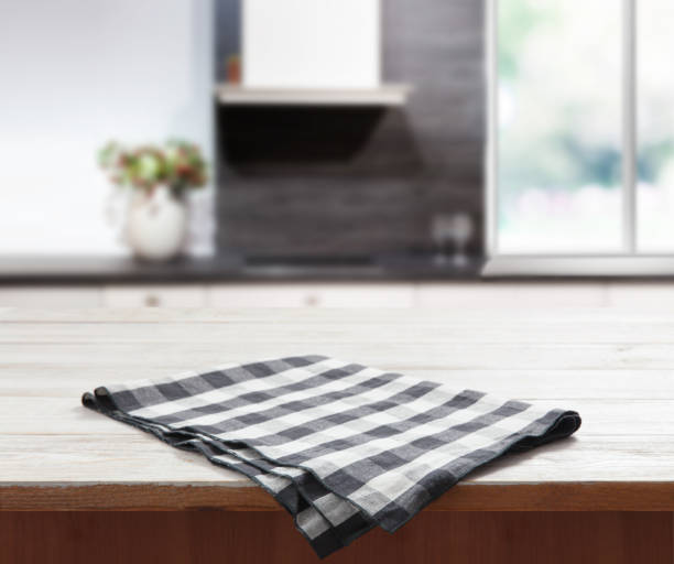 istock Napkin on wooden desk perspective. Kitchen background. 1304900750
