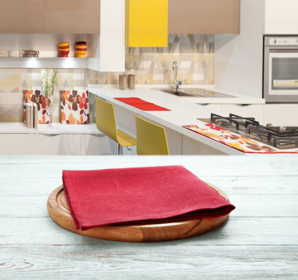 istock Napkin and board for pizza on wooden desk. Kitchen background. 1304900767