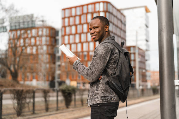 istock Man reading a paperback book in the city 1304901205
