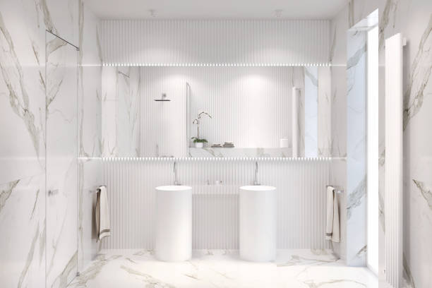 white bathroom with large rectangular mirror above two freestanding washbasins, shelf for bathroom accessories, towels, marble floor and walls, window and door, spotlights on the ceiling. - tile bathroom tiled floor marble imagens e fotografias de stock