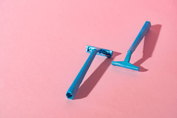 istock Blue disposable razors on pink paper background 1304902830