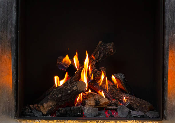 istock Wood logs burning in fireplace close up 1304903804