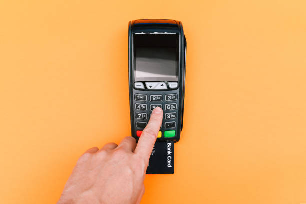 man entering a password at a pos terminal. wireless, contactless or cashless payments, rfid nfc. payment by credit card, purchase and sale of goods and services - bar code computer keyboard retail computer imagens e fotografias de stock