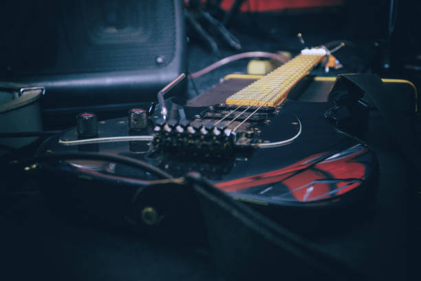 Black electric guitar with tremolo on a hard case