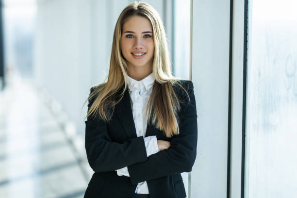 istock Young businesswoman standing with arms folded at office 1304911556