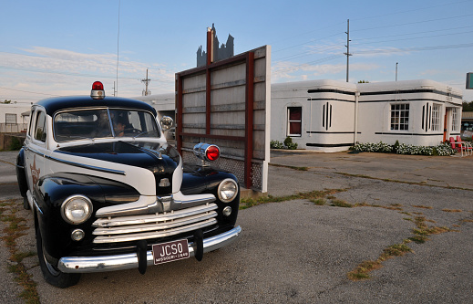 Carthage, MO, USA, Oct. 5, 2019: A classic police car sits on display near the Boots Court Motel, a Route 66 landmark in the city of Carthage, Missouri.