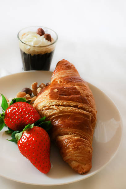 istock French Croissant and strawberries coffee 1304915304