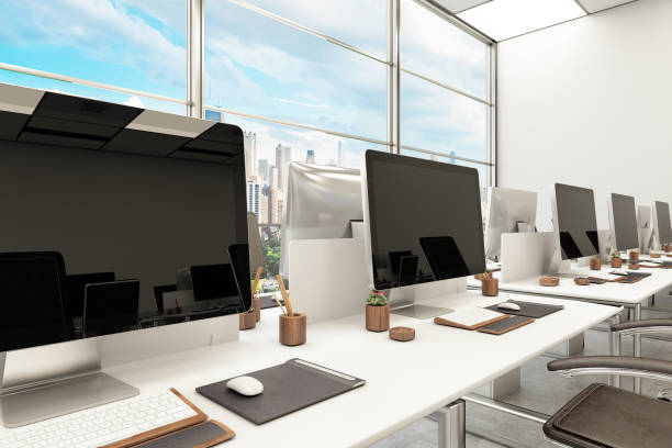 Office with Row of Computer Monitors Standing on Desks Office with Row of Computer Monitors Standing on Desks. 3d Render classroom empty education desk stock pictures, royalty-free photos & images