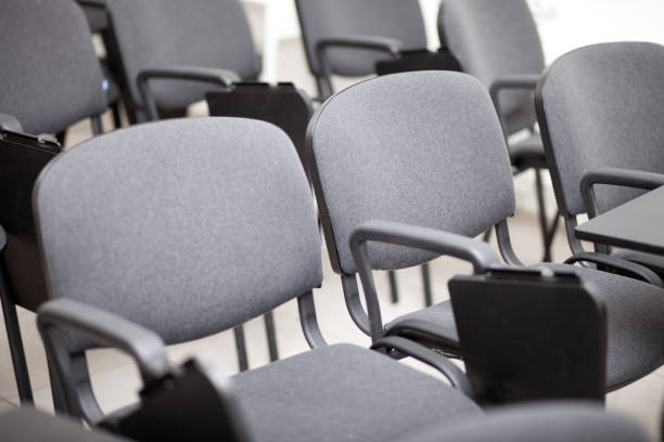 istock grey chair seats in an empty conference room 1304916411