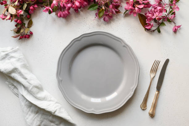 istock Elegance table setting with blooming apple flowers on white table. 1304918163