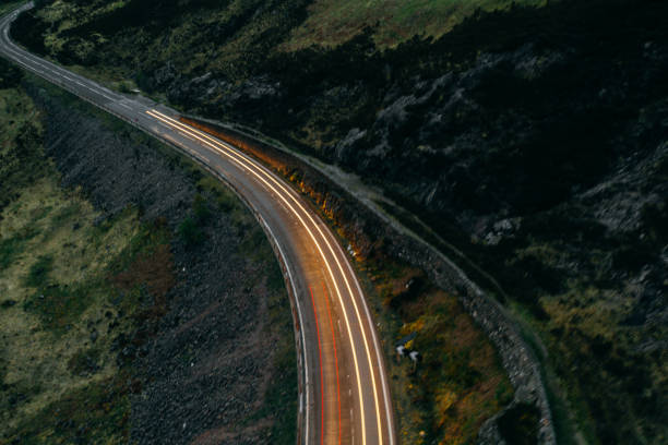 istock Car light trails on a countryroad 1304918480