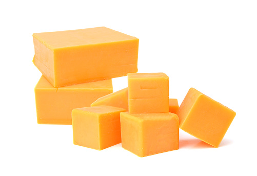 Cubes of cheddar cheese isolated on white