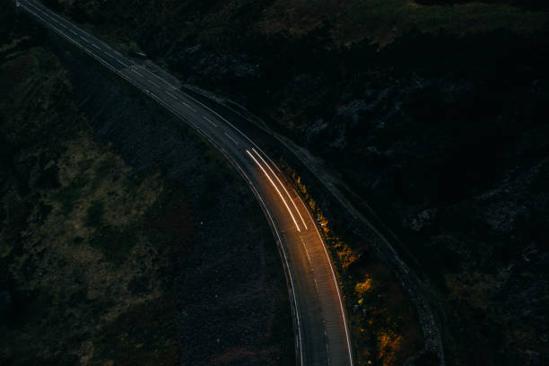 istock Car light trails on a countryroad 1304918905