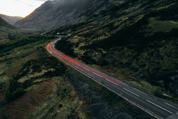 istock Car light trails on a countryroad 1304920508