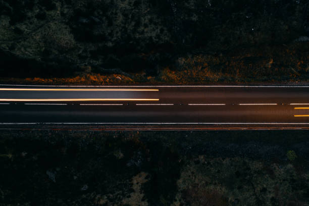 istock Car light trails on a countryroad 1304921173