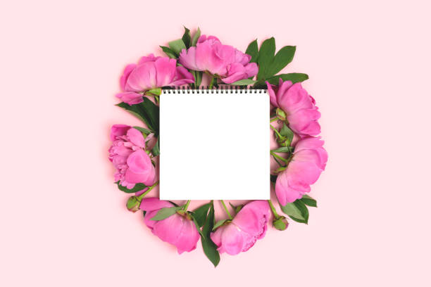 istock Blank notepad mockup with frame made of peony flowers. 1304924738