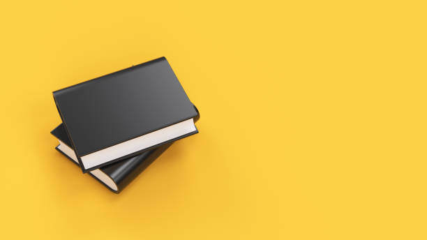 istock Black books without text on the cover on yellow background 1304925809
