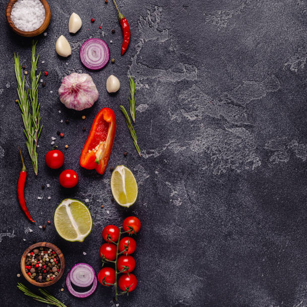 istock Herbs and condiments on black stone background 1304926311